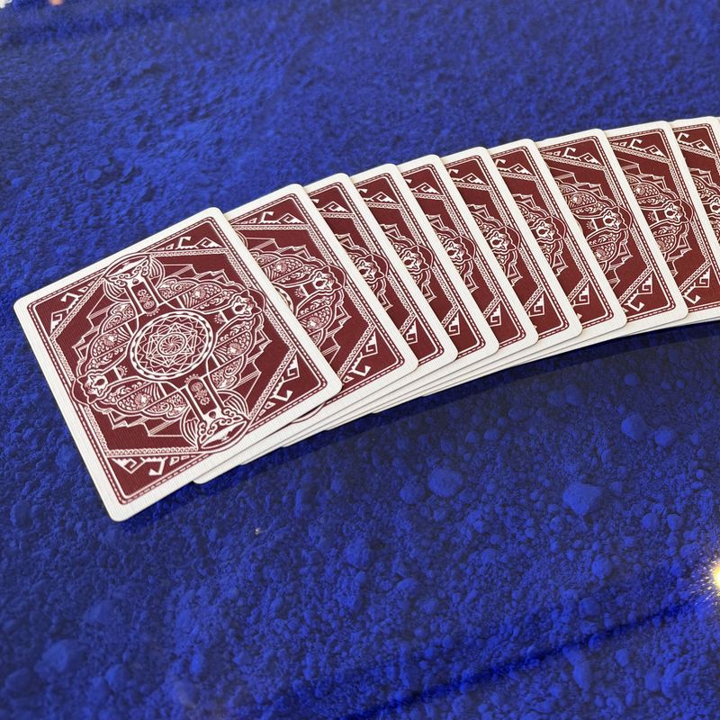 A ribbon spread of Fragments cards running across a deep ultramarine pigment surface